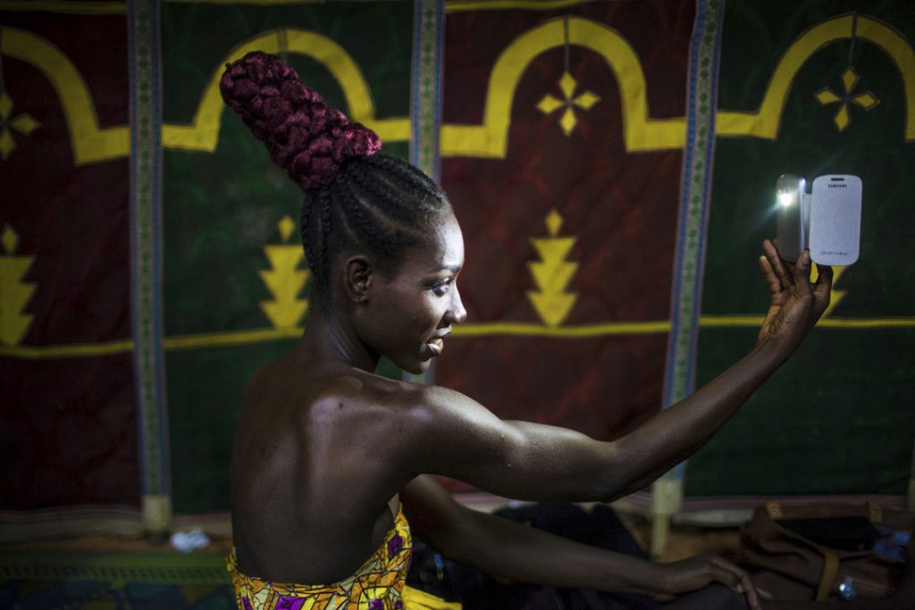 Model Mercy Ashie takes a selfie just after having her hair done for the catwalk.