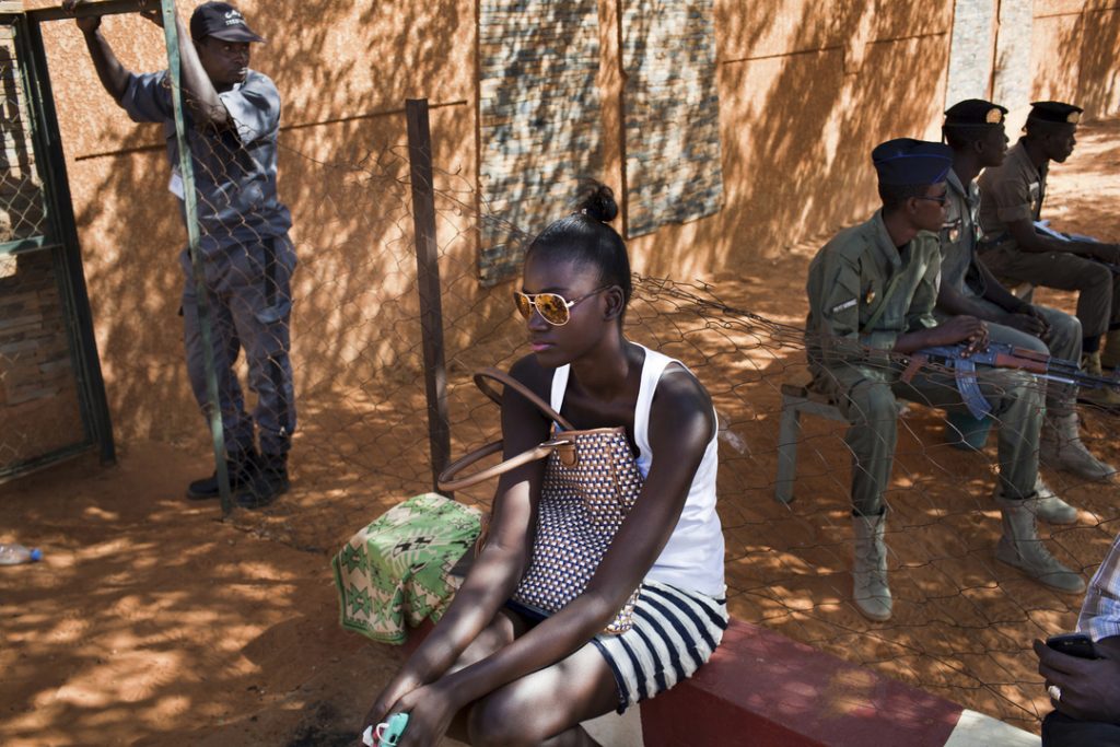 A model awaits at the entrance of the "Centre Aere de la BCEAO", where the FIMA is taking place. Due to the danger of a terrorist atack special security measures are being taken to avoid any problems. The growing islamization of the country also makes this kind of international event more difficult to be accepted from an important part of the population.