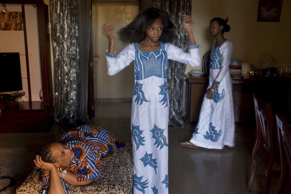 Miriam and Nadia with their mother in the living room. They came back from church.